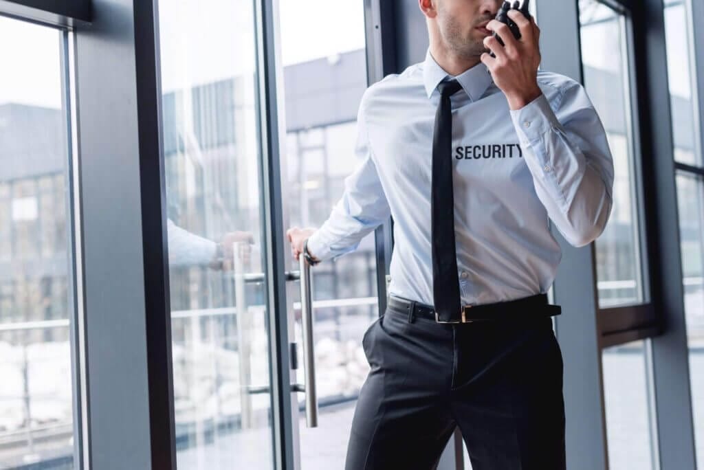 A man in a white shirt and tie talking on the phone.