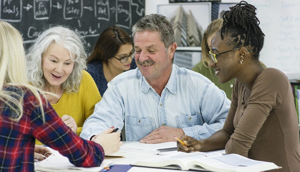 Four people sitting together in a casual setting, engaged in conversation