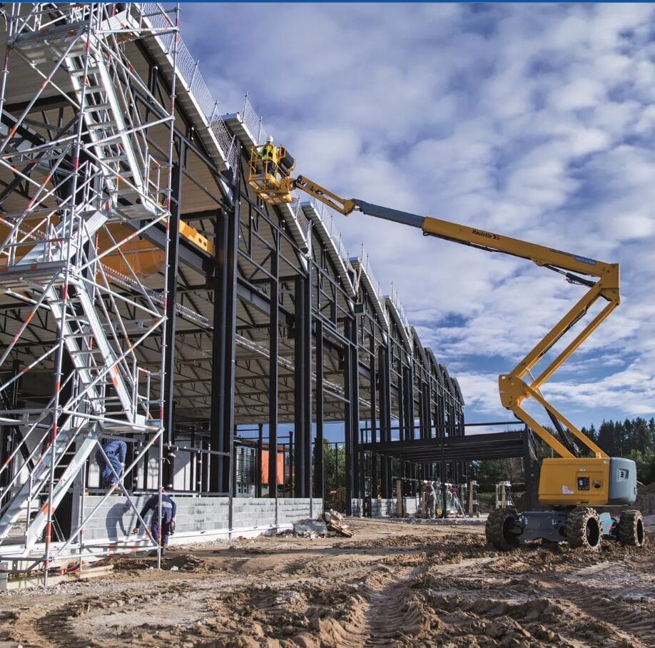 A crane is lifting up the structure of a building.