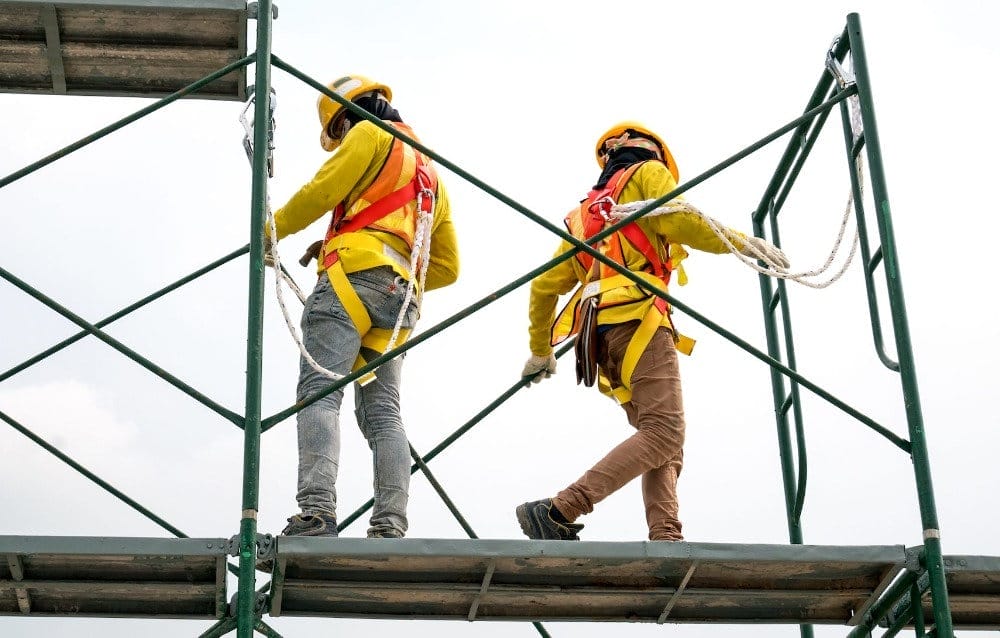 Two men standing on scaffolding