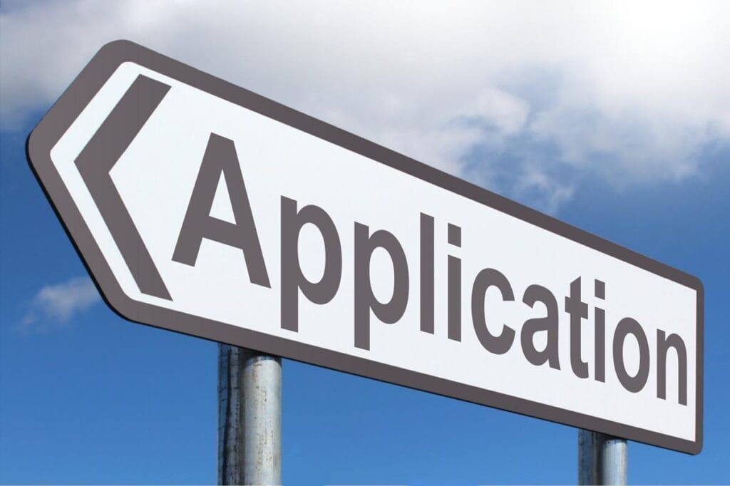 A street sign that says application