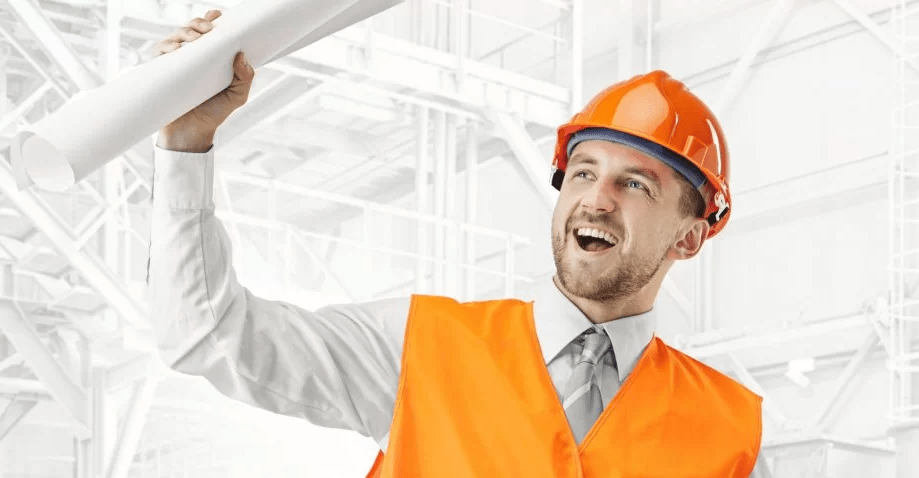 A man in an orange vest and hard hat holding up something.